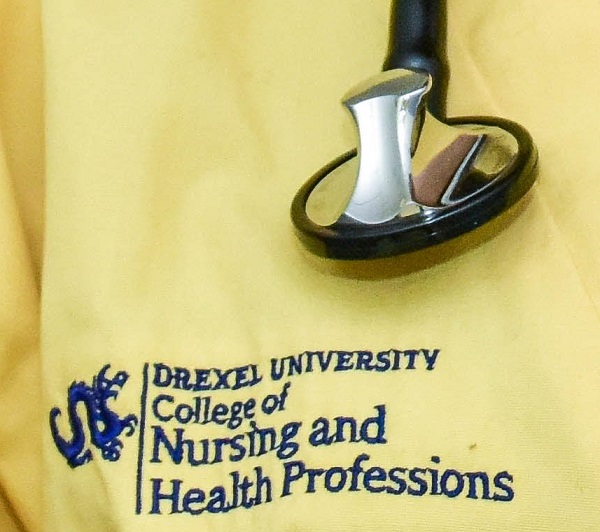 CNHP's logo on yellow scrubs with stethoscope